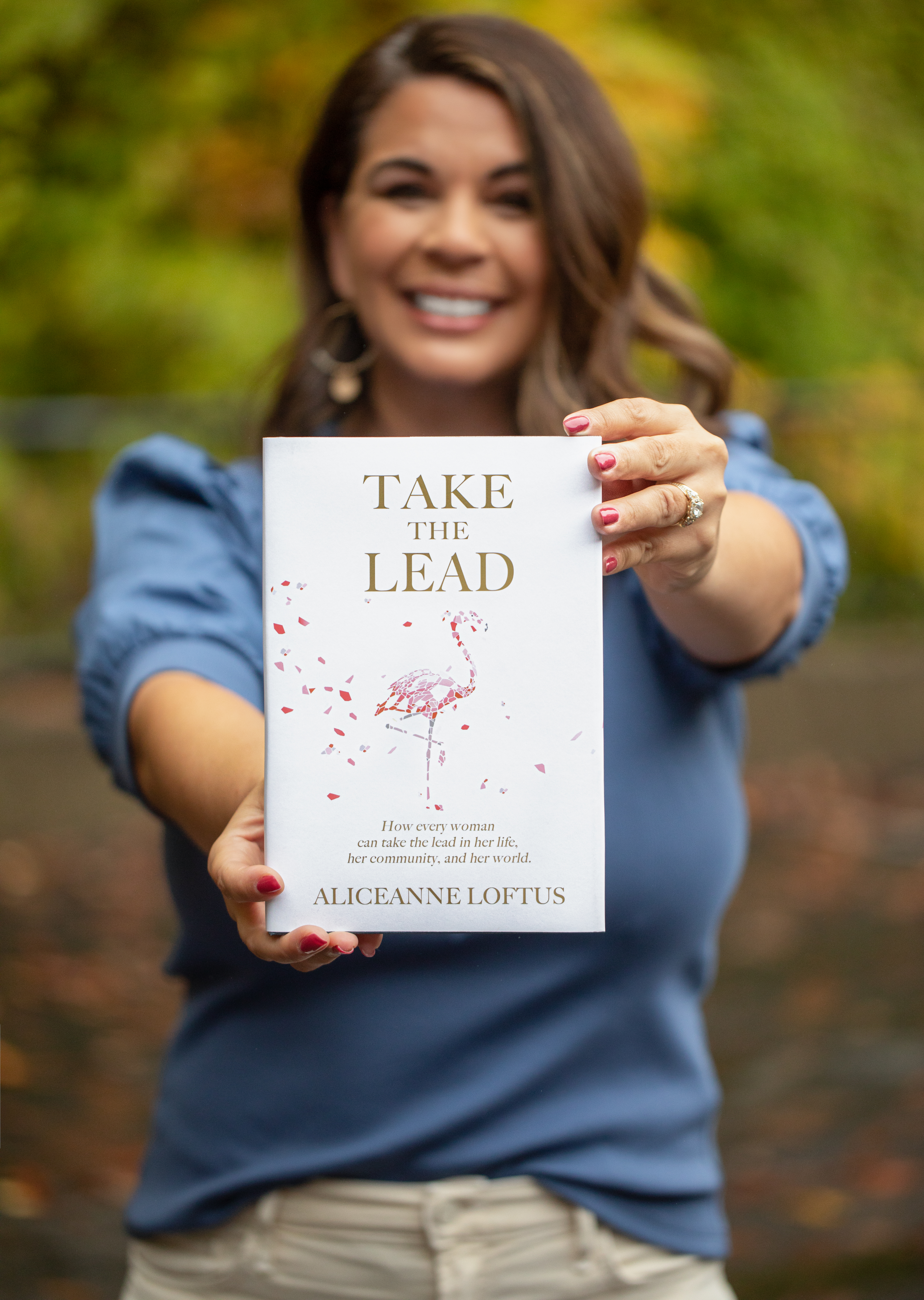 AliceAnne holding Take the Lead book