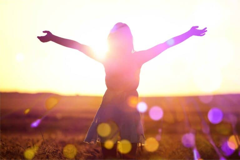 Woman standing with her arms outstretched