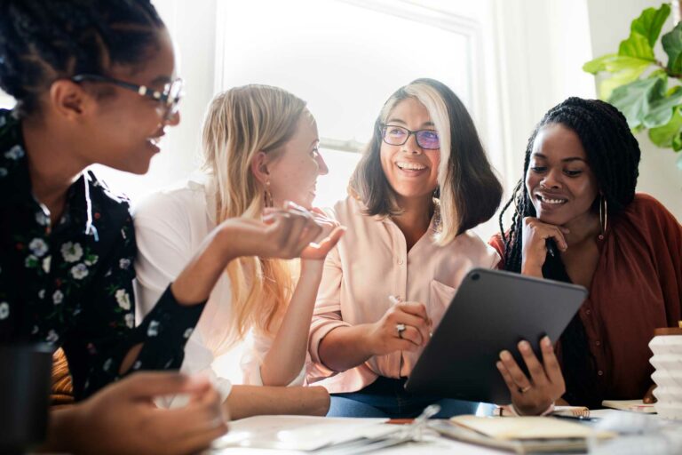 Group of four women engaged in conversation