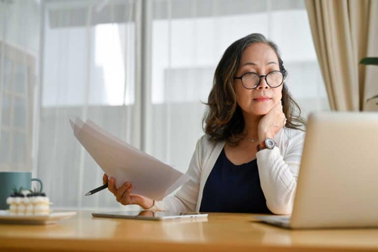 Woman on her computer trying to figure out how to write a business plan