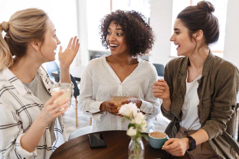 A group of three women using their communication skills to have a conversation