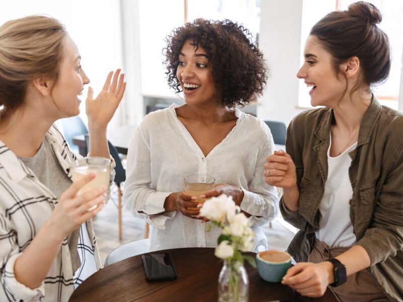 A group of three women using their communication skills to have a conversation