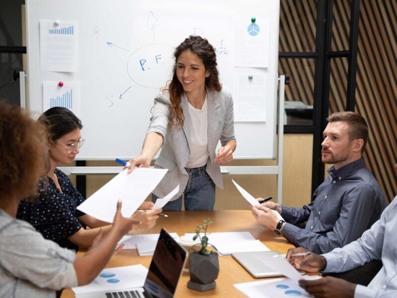 Woman delegating tasks to her team