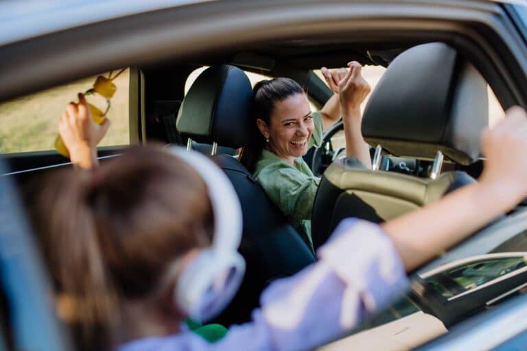 Woman driving her child to school because she's working smarter, not harder