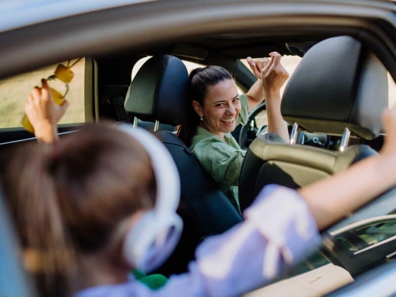 Woman driving her child to school because she's working smarter, not harder