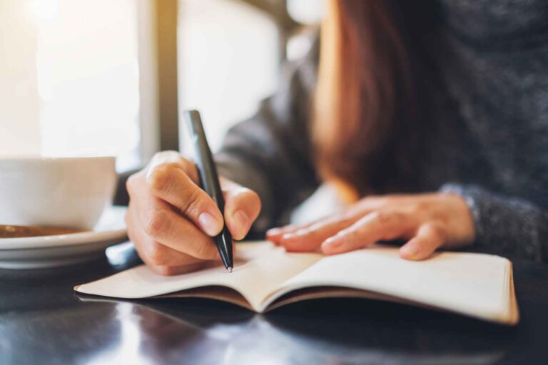 Woman documenting her standard operating procedures in a notebook