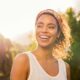 Woman smiling in the sunlight about her mindset shift